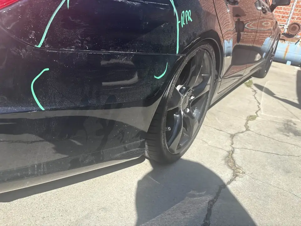 Before: right quarter panel and rear wheel of a 2013 Mercedes-Benz CLS550 with damage areas marked