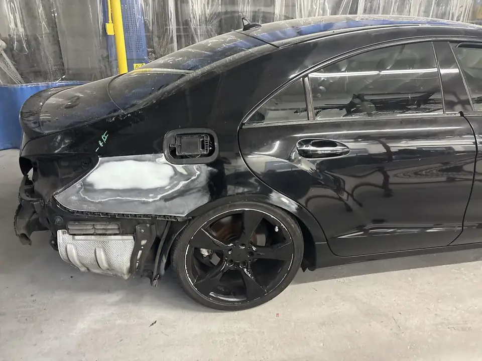 During: 2013 Mercedes-Benz CLS550 right quarter panel in body filler with rear bumper cover removed