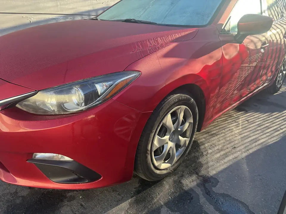 After: 2014 Mazda 3 Sport left fender, hood and front door after repair and candy apple red refinish