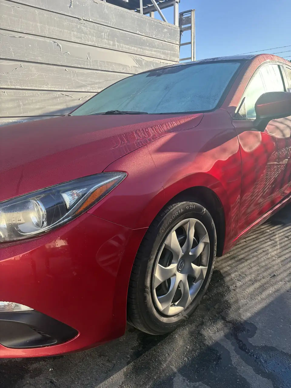 After: left front of the repaired 2014 Mazda 3 Sport, angled view