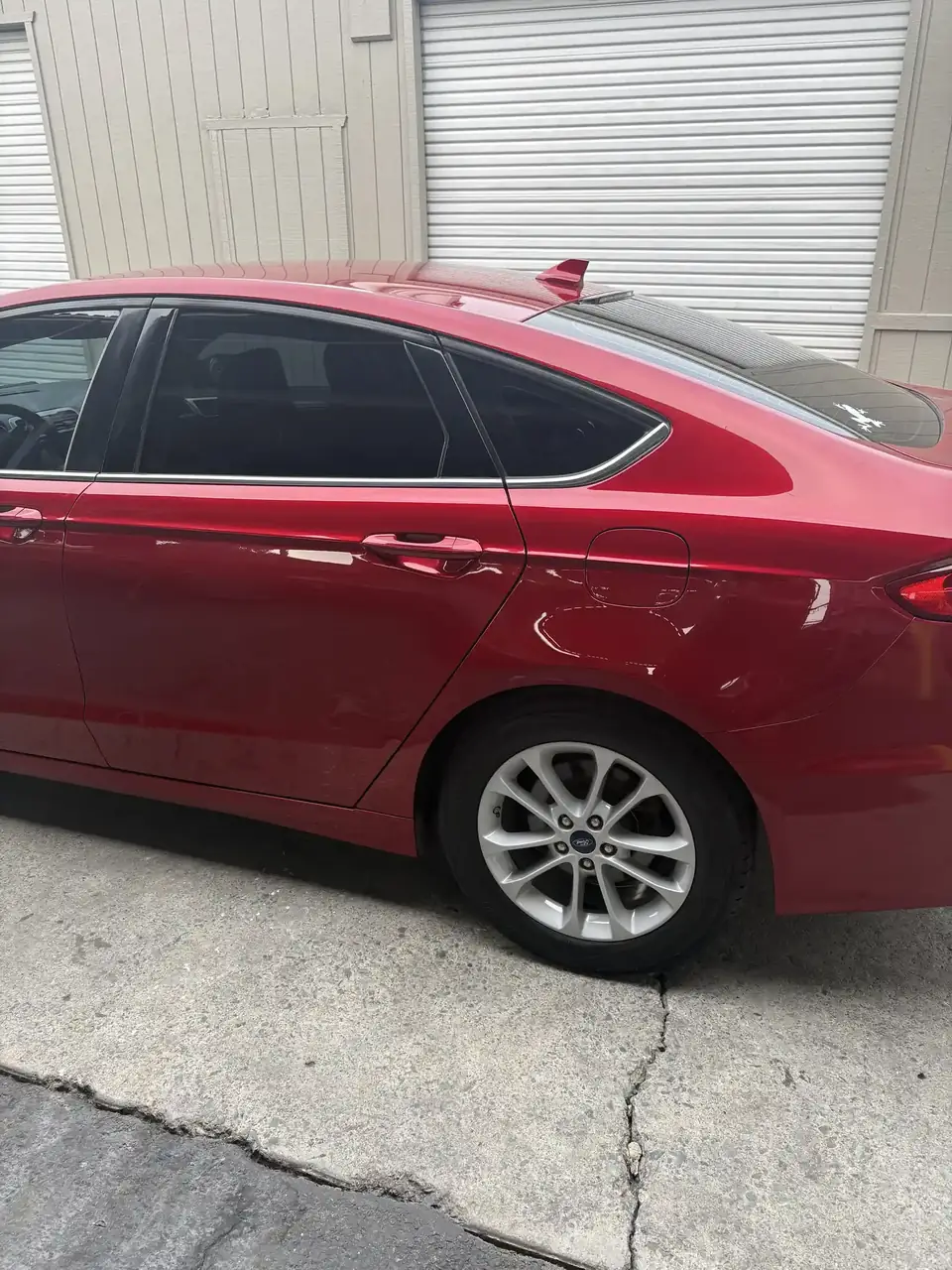 After: left quarter panel and rear wheel of the 2020 Ford Fusion after repair