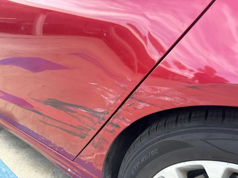 Before: scratches and dents at the left rear door and quarter panel seam of a 2020 Ford Fusion