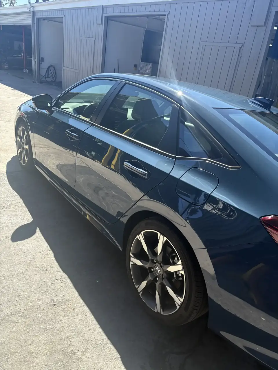 After: 2025 Honda Civic left side from the front after repair, showing matched paint