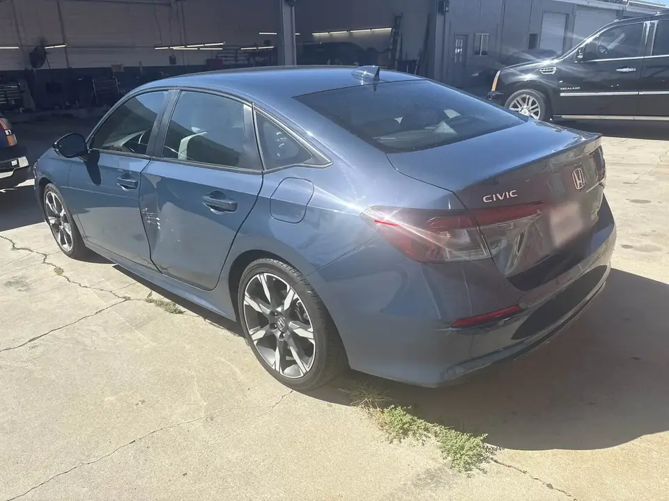 Before: 2025 Honda Civic rear three-quarter view of left side damage