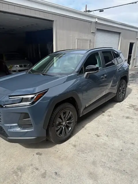 After: 2026 Toyota RAV4 XLE front bumper, fender and front door after repair, front three-quarter view