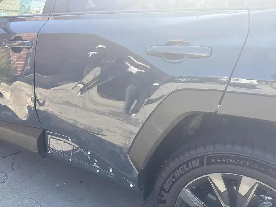Before: damaged left rear door and quarter panel on a 2026 Toyota RAV4 XLE