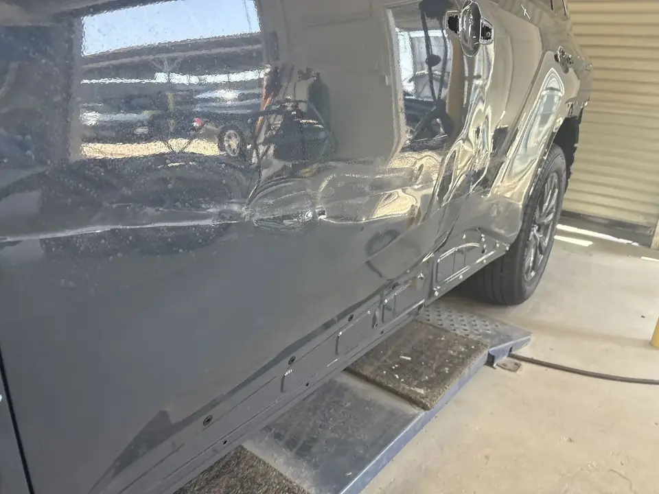 Before: creased left doors on a 2026 Toyota RAV4 XLE in the shop
