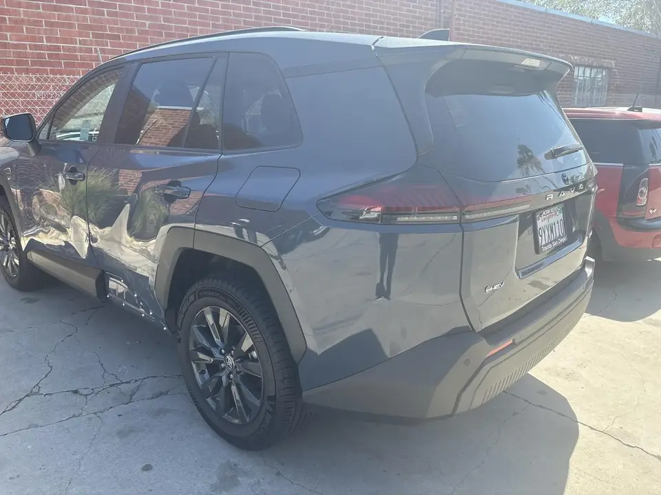 Before: 2026 Toyota RAV4 XLE rear three-quarter view of left side damage