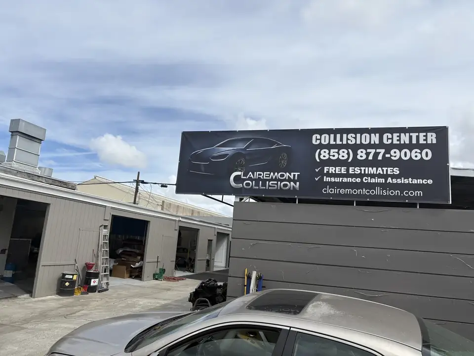 Clairemont Collision Collision Center banner with (858) 877-9060, free estimates and insurance claim assistance, above the shop bays at 7996 Armour St, San Diego