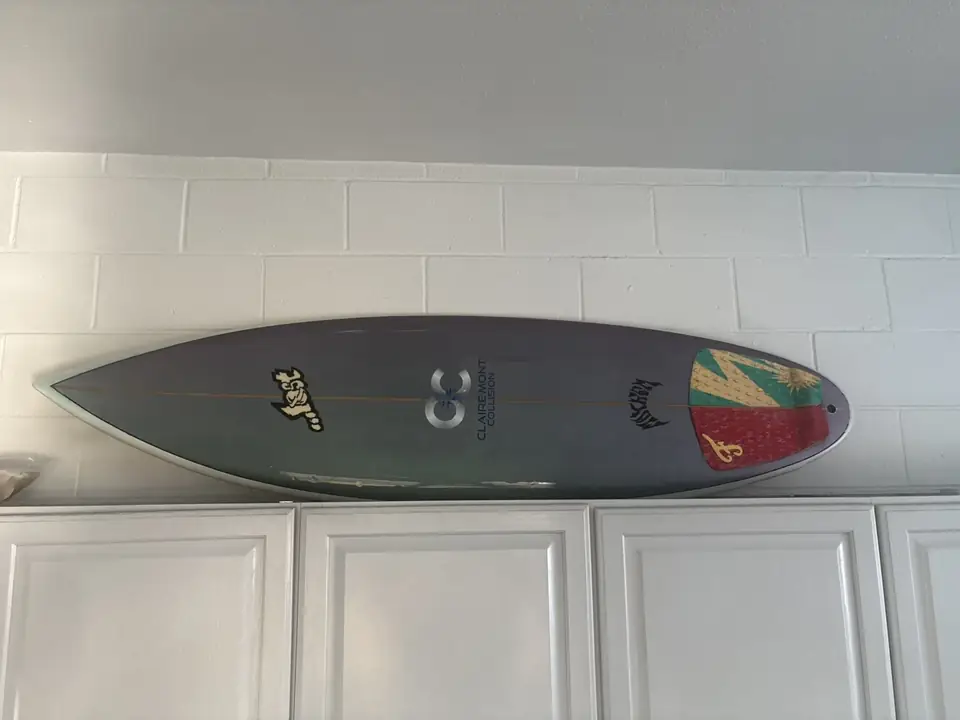 Custom surfboard painted by the Clairemont Collision paint shop, mounted above the cabinets in our San Diego waiting area